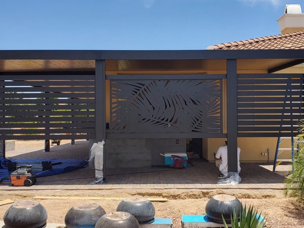 Modern dark aluminum patio cover with privacy slats for Henderson area homeowners.