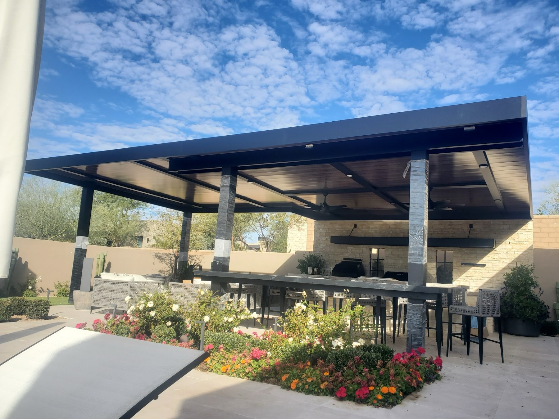 Large dark aluminum patio cover over outdoor furniture for Summerlin area homes.