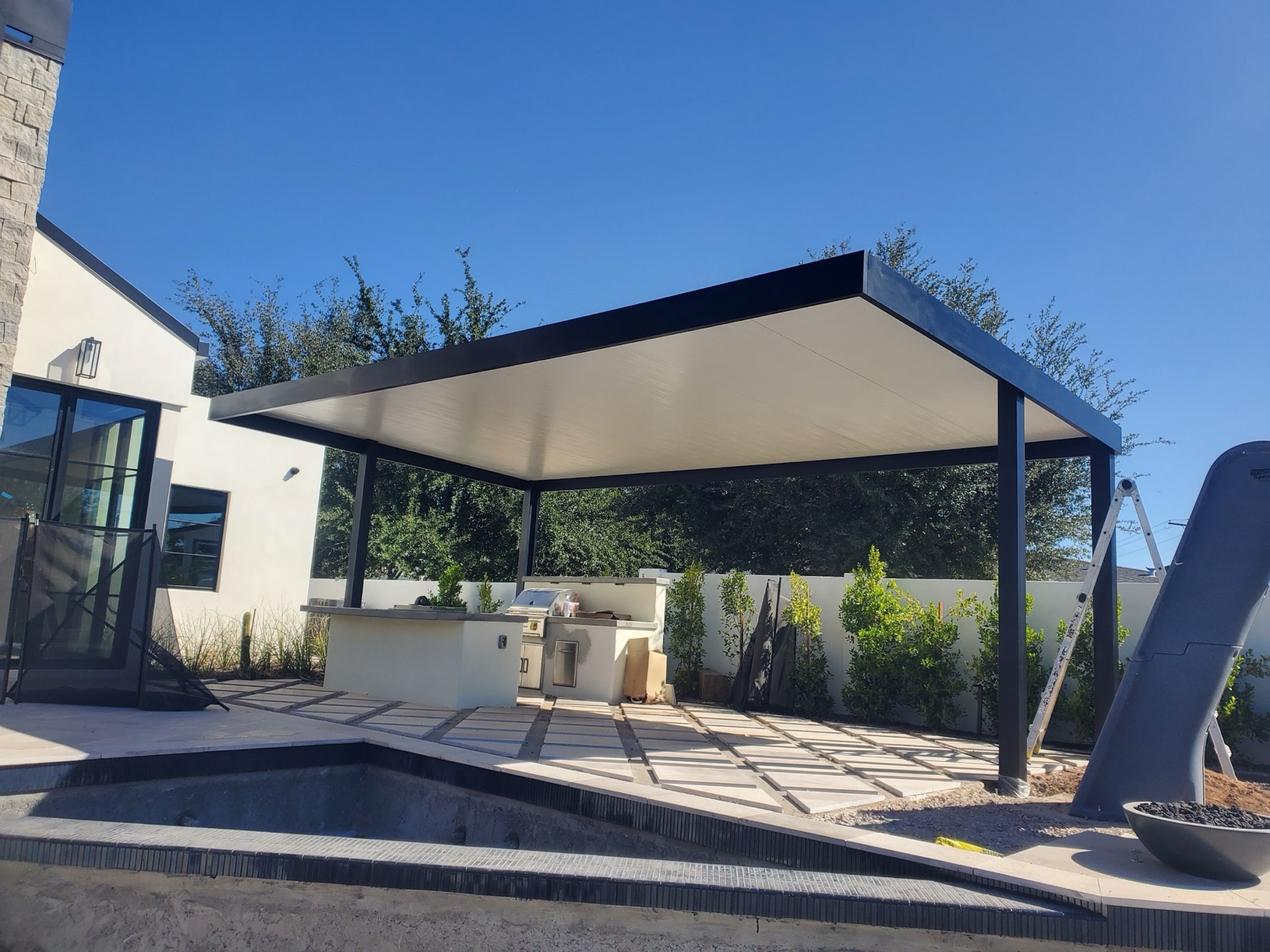 Black freestanding solid patio cover for Henderson area backyards.