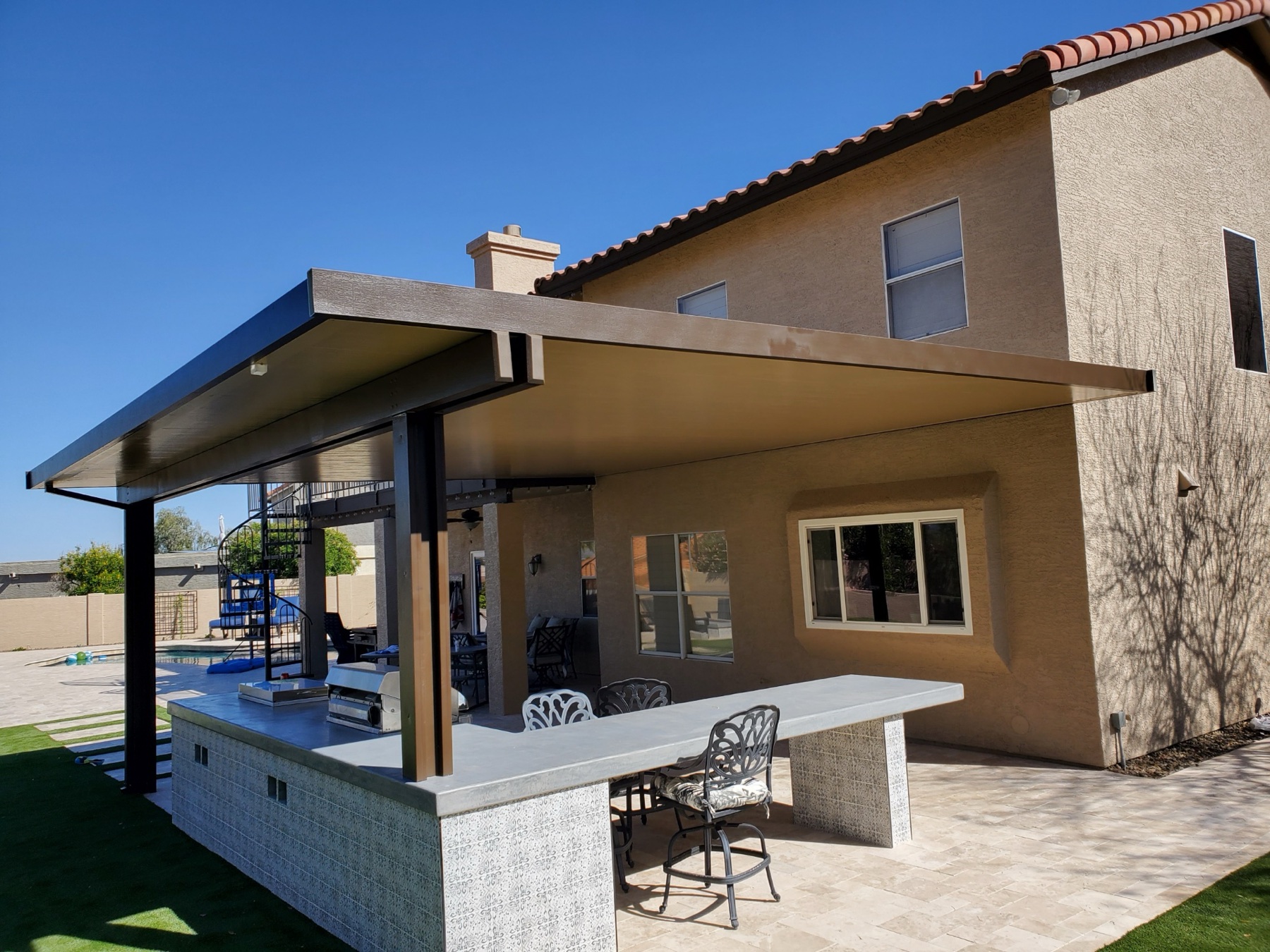 Attached patio cover over an outdoor kitchen for Summerlin area homes.