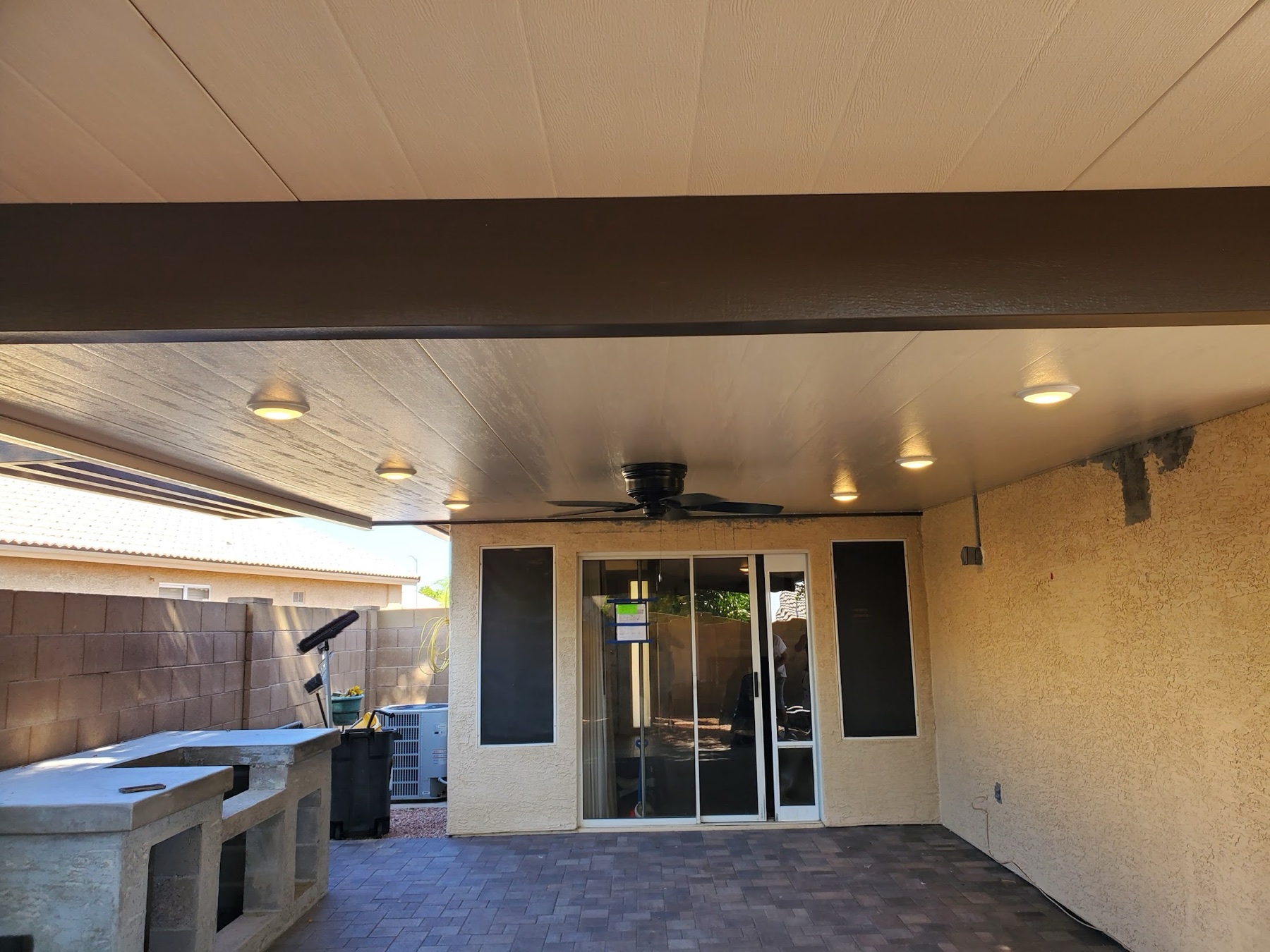Insulated patio cover with ceiling fan and lights for Henderson area homes.
