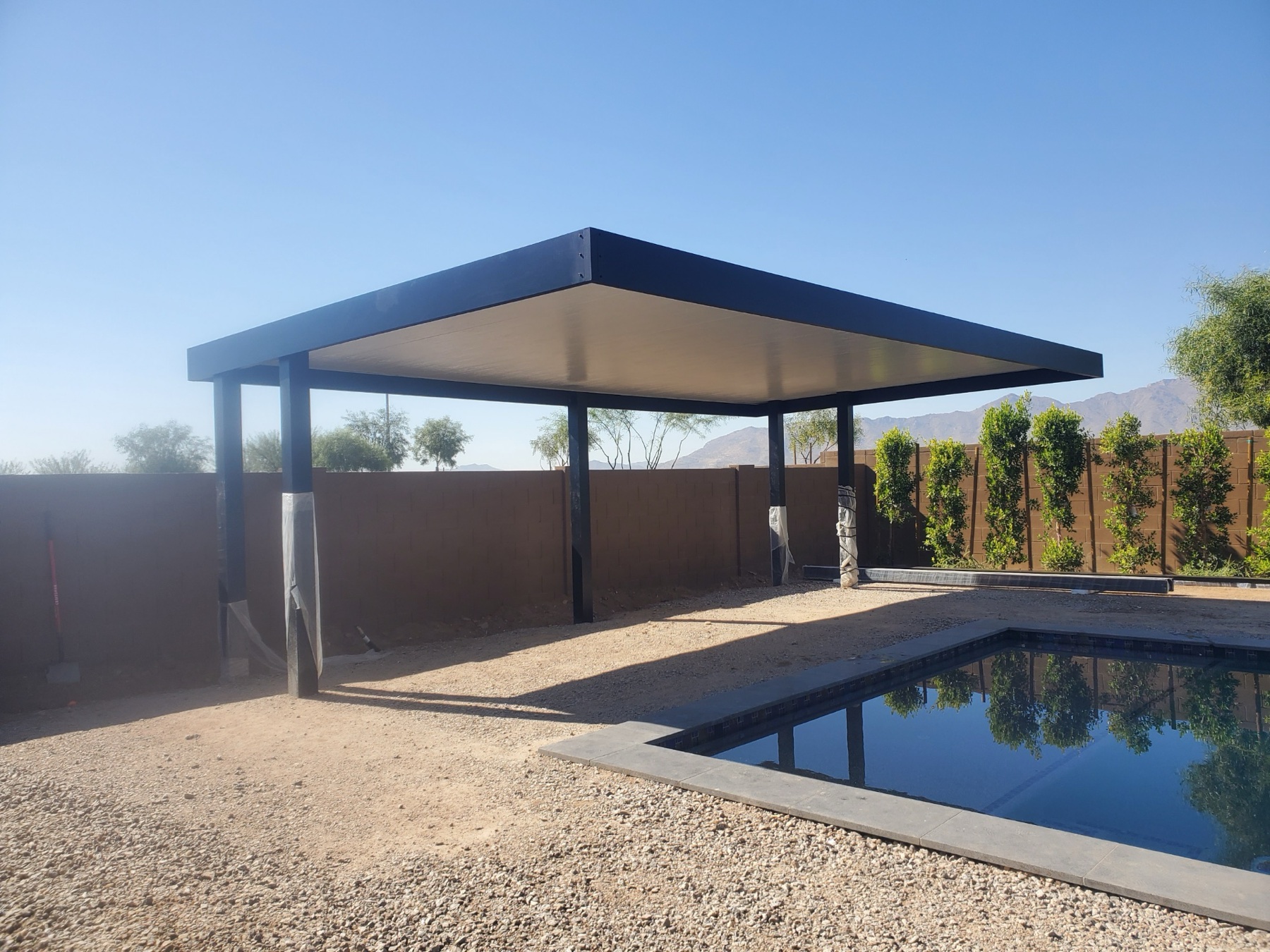 Dark freestanding pool shade cover for Las Vegas area backyards.