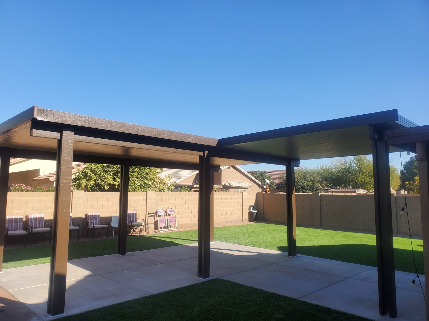 Black freestanding patio cover over lawn for Summerlin area homeowners.
